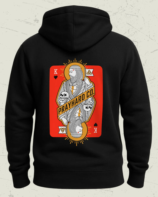 Black hoodie with a King over death playing card design on the back, featuring 'PRAY HARD CO.' text.