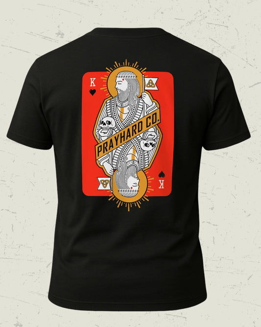 Black t-shirt with a graphic design of a king over death playing card on a textured white background