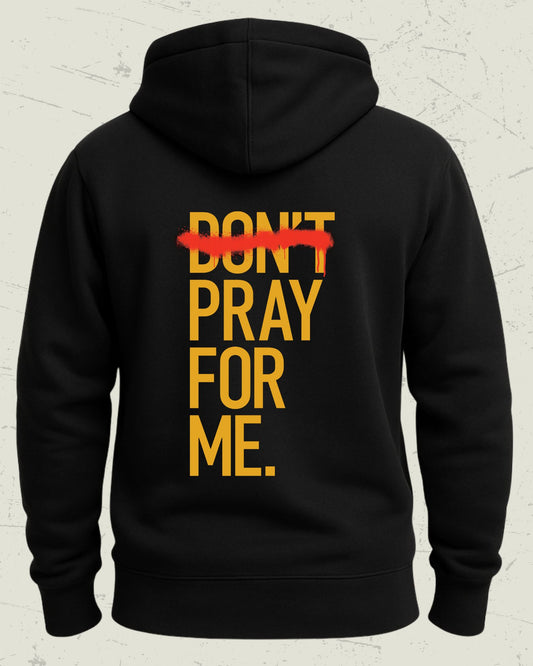 Black hoodie with yellow text 'DON'T PRAY FOR ME' on the back against a light gray background